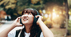 Woman, headphones and worker travel or thinking in city, streaming playlist and online for listening. Female person, outdoor employee and hearing sound on journey in Japan, urban town and planning