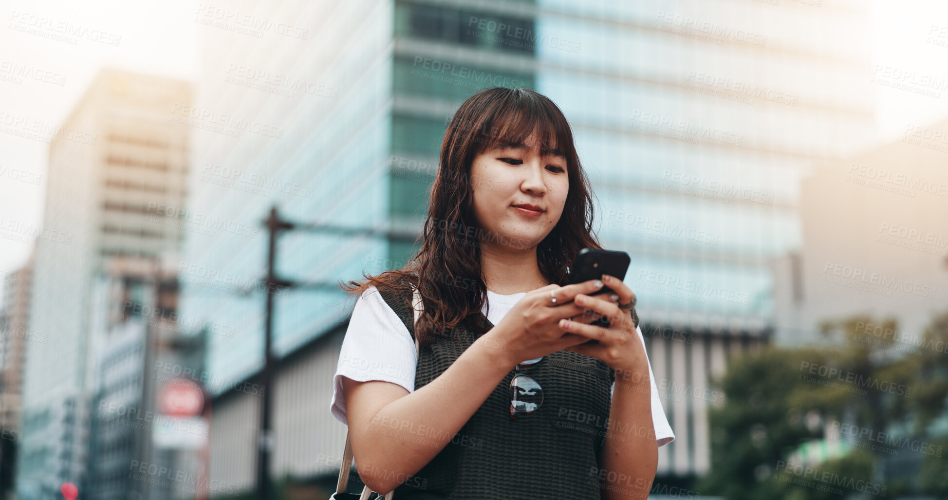 Buy stock photo Woman, phone and travel in city of Japan, walking and online for professional chat. Female person, commute and urban town for communication on app, business website and worker consulting on internet