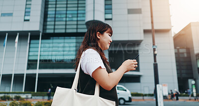 Buy stock photo Woman, phone and walk in city, travel and smile with texting, map and search for location in street. Girl, person and happy with smartphone on commute, sidewalk and chat on mobile app in Japan