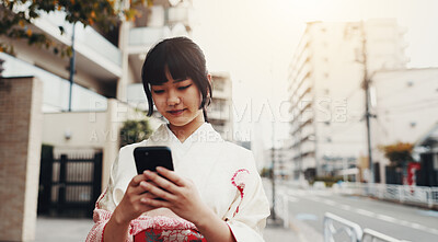 Buy stock photo City, phone and Japanese woman with kimono, typing and connection for social media on morning commute. Travel, traditional clothes and girl in urban street on mobile app on smartphone for online chat