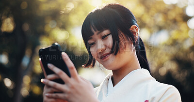 Buy stock photo Japanese woman, park and phone texting with mobile notification, tech and social media outdoor. Online, student and campus with website, internet chat and contact with smile, nature and typing