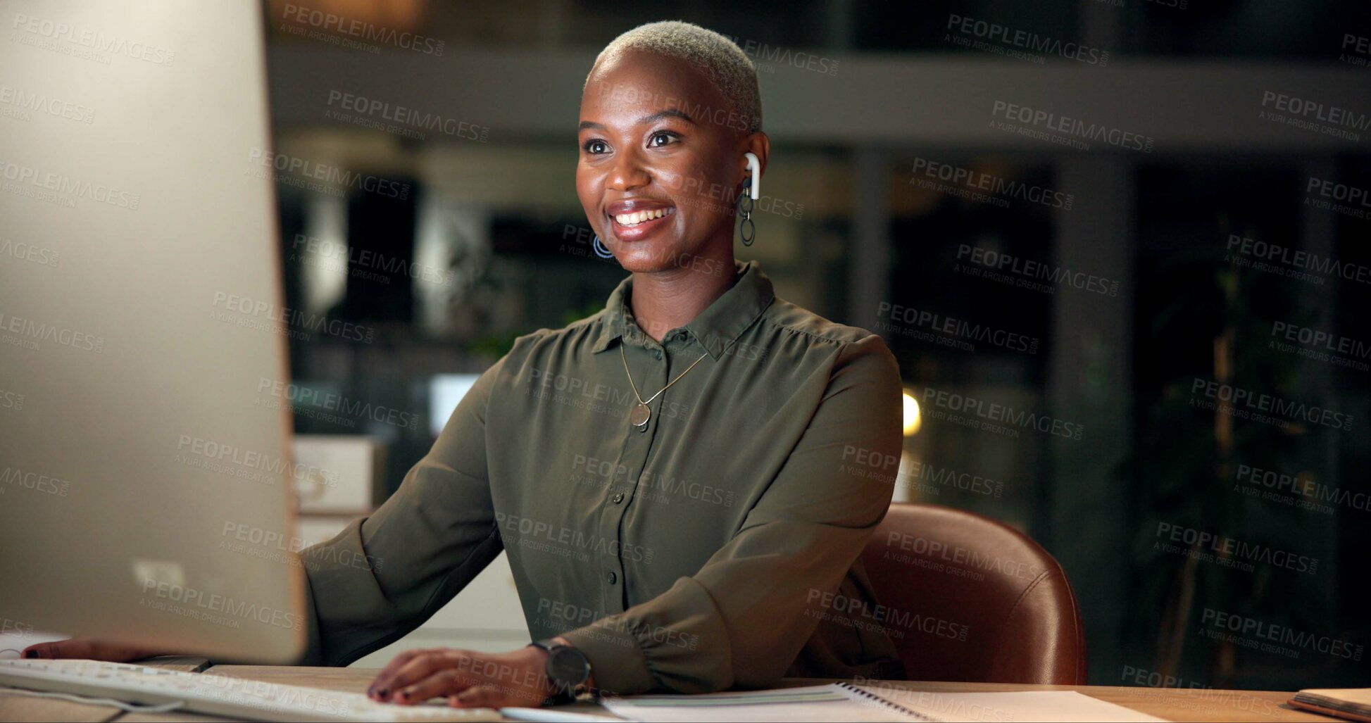 Buy stock photo Black woman, earphones and computer in office for reading, business research and news at night. Economy journalist, music and tech in agency for article resource, proofreading and stock market study