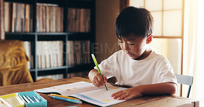Buy stock photo Asian boy, writing and learning with book for drawing, sketching or childhood development at home. Japan, kid or child with coloring crayons, talent or skill for creativity, art or education at house