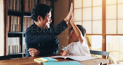 Buy stock photo Asian father, child and learning with high five for education, homeschooling or youth development at home. Dad, boy or kid with homework, winning or teamwork for creativity or childhood in Japan