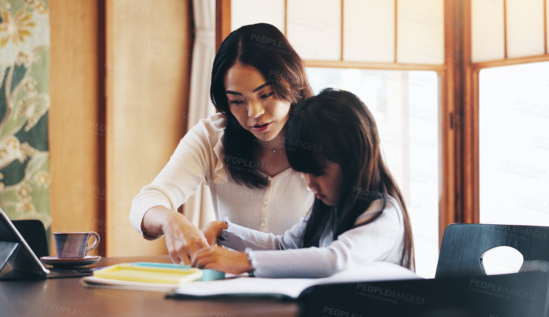 Buy stock photo Asian mother, child and learning with book for education, homeschooling or youth development at home. Mom, girl or kid with homework or lesson for knowledge, academic growth or tutoring in Japan