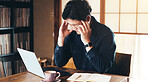 Asian man, headache and laptop with stress for debt, bankruptcy or pain in burnout at home. Japan, male person or freelancer with migraine, anxiety or vertigo for mistake, fail or dizziness at house