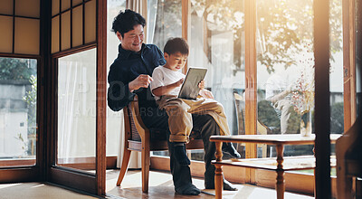 Buy stock photo Man, child and tablet in home for media, streaming and watching funny video at window. Japanese family, technology and bonding in living room with memory skill game, fun app and kid with happy father