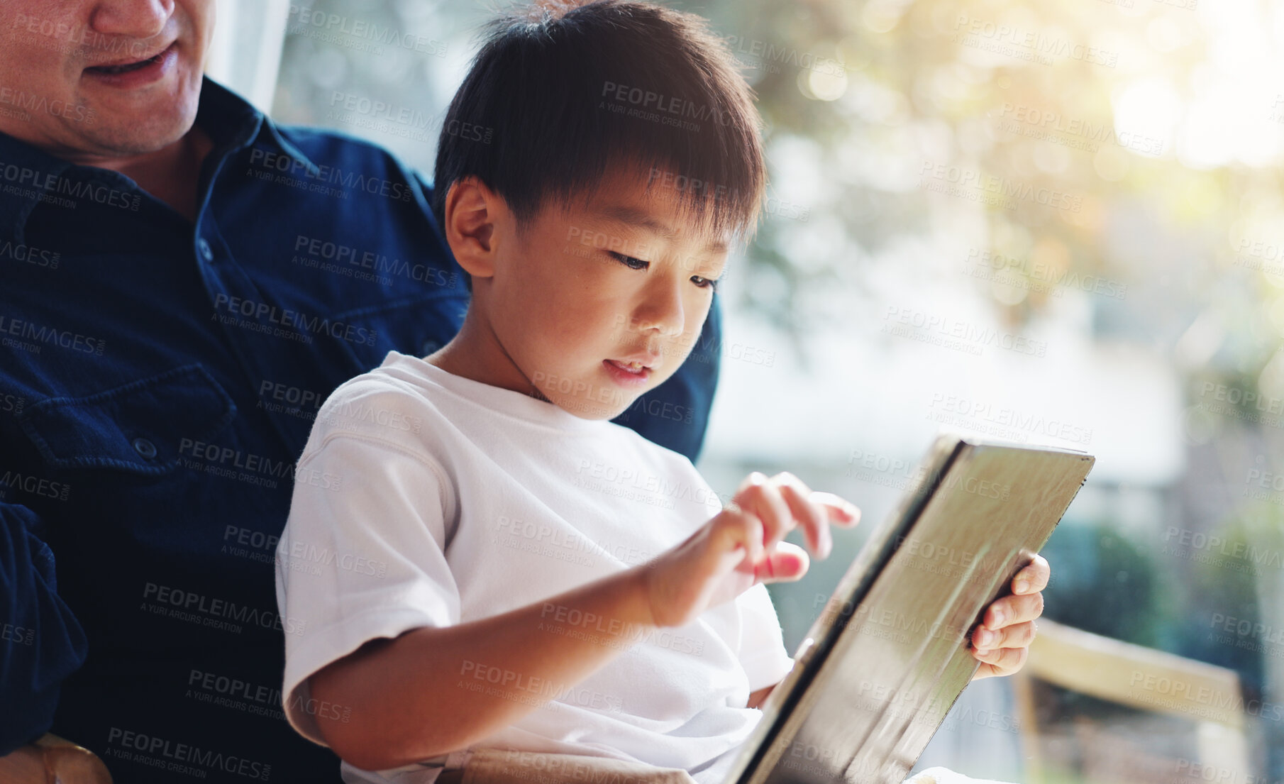 Buy stock photo Asian, father and boy with tablet for childhood development, interaction or online browsing at home. Japan, dad and son with technology, reading or education for elearning, engagement or UX at house