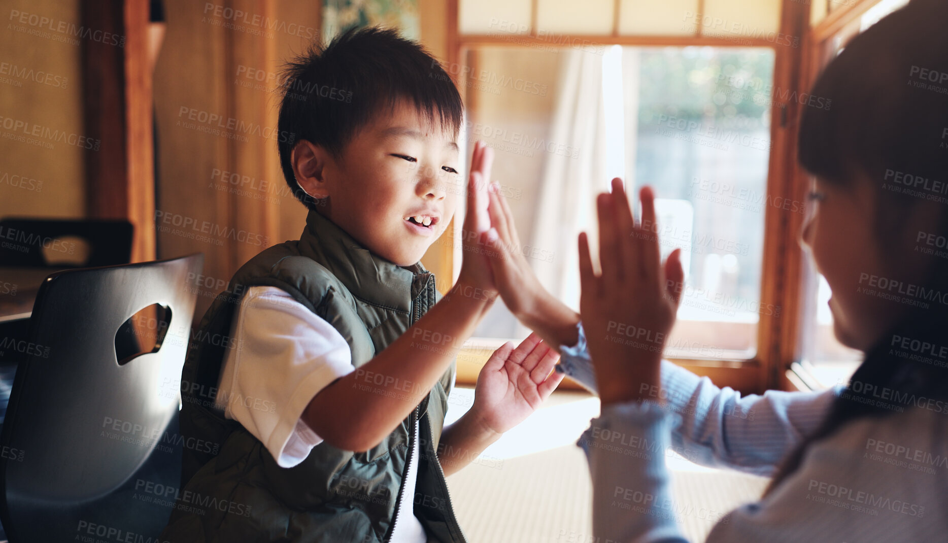 Buy stock photo Family, children and playing clapping game for bonding, cognitive development or coordination. Japanese people, kids or fun activity in living room for learning, interaction and motor skills on floor