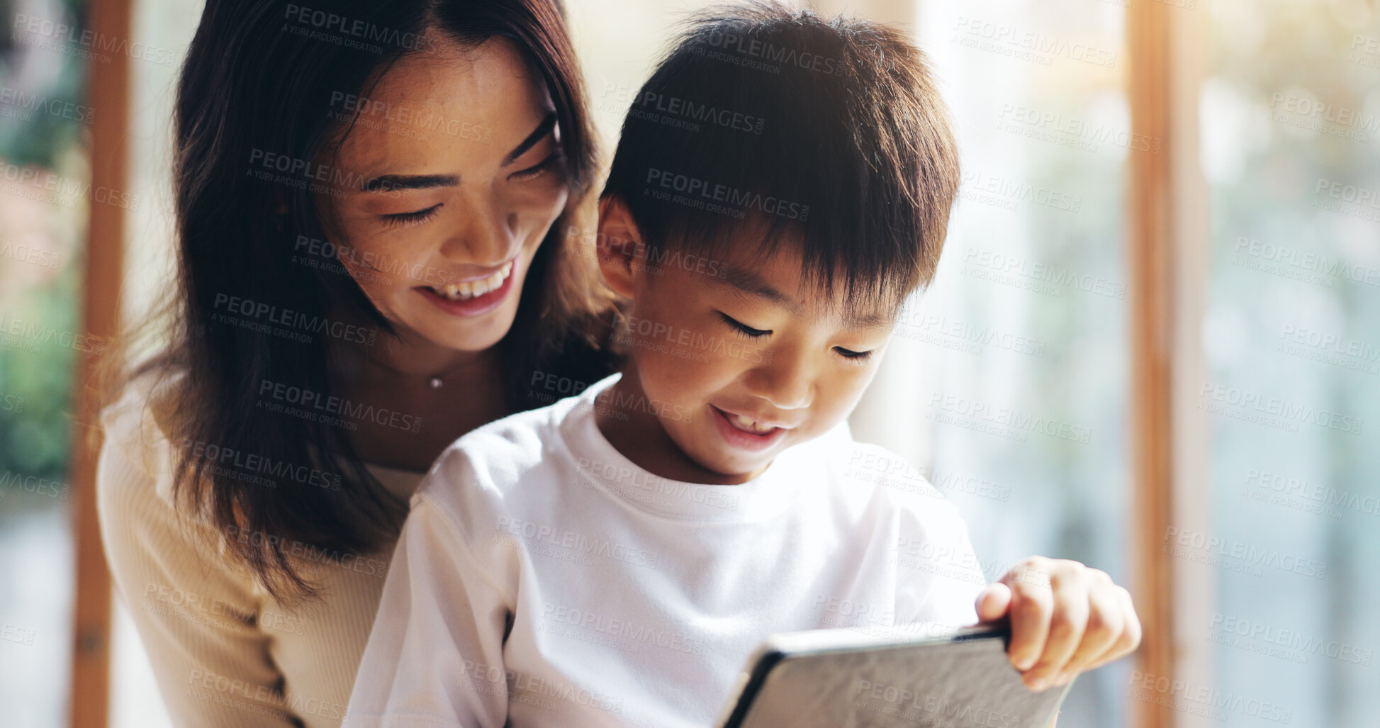 Buy stock photo Mother, son and tablet in home for bonding, playing games or streaming cartoon video with internet. Japanese family, boy and mom together with technology for teaching, development or online education