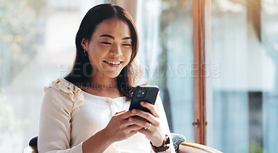 Buy stock photo Japanese, woman and typing with phone at house for communication, social media and reading blog. Female person, window and smile with mobile for contact, website information and morning news in Japan