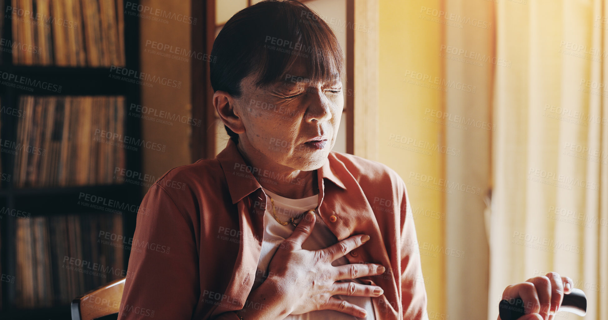 Buy stock photo House, heart attack and senior woman with walking stick, pain and medical with asthma. Japanese person, apartment and pensioner with cane, anxiety and emergency with breathing and cardiology