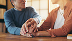 Couple, holding hands and empathy in home for help, support or hope in Japan. Mature man, woman and gesture in living room with love, trust and commitment in marriage with care for mental health