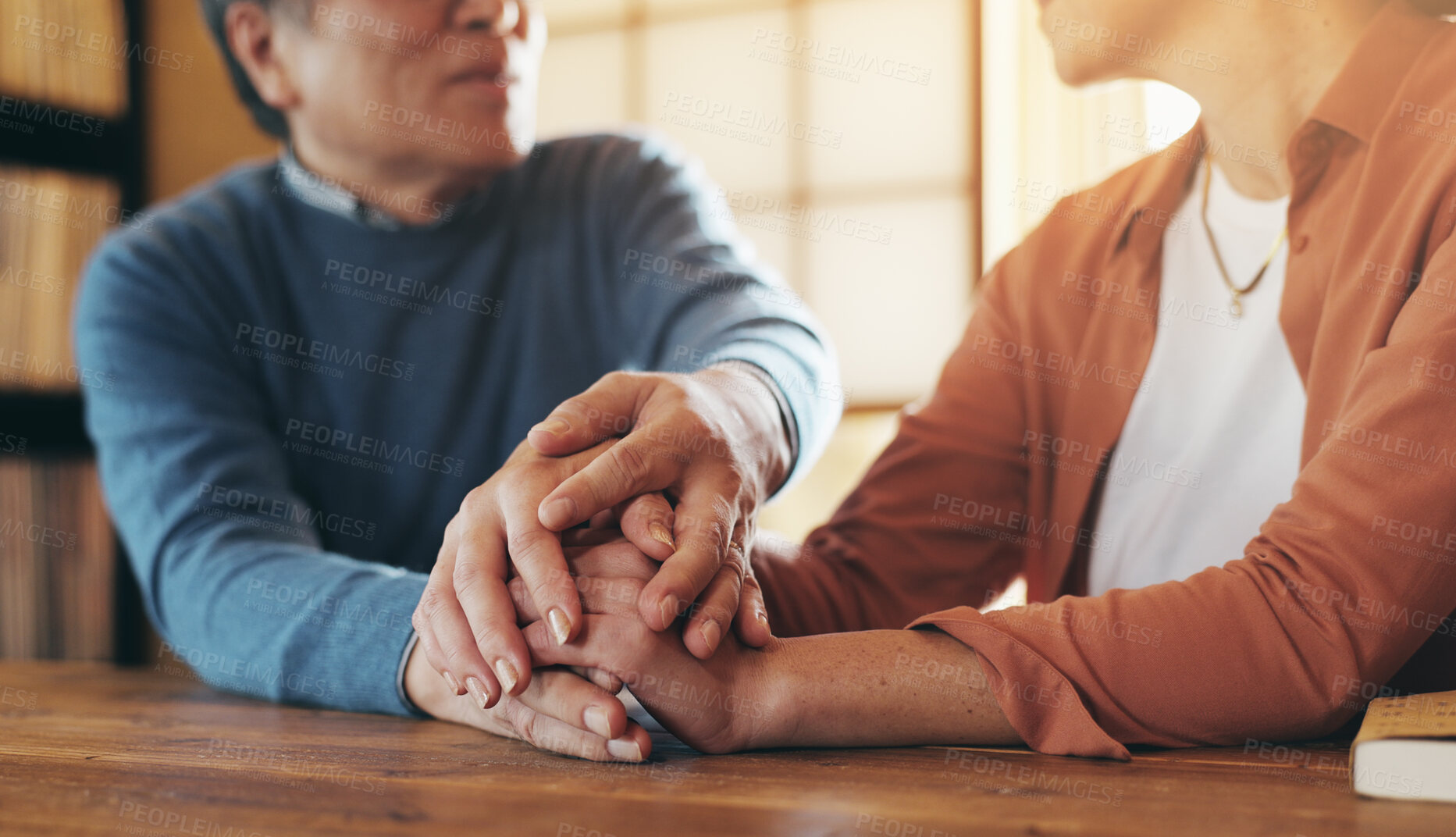 Buy stock photo Couple, holding hands and empathy in home for help, support or hope in Japan. Mature man, woman and gesture in living room with love, trust and commitment in marriage with care for mental health