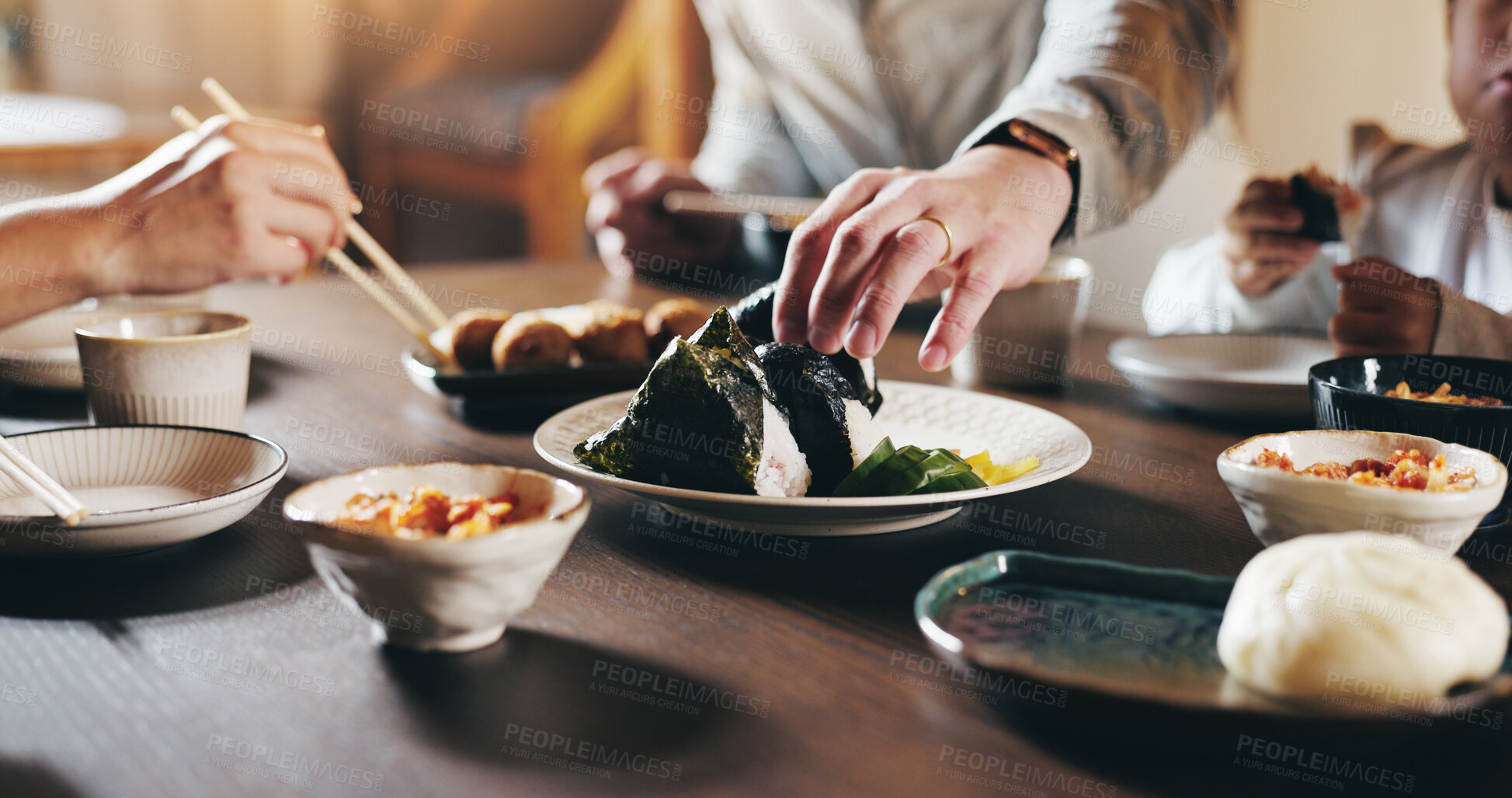 Buy stock photo Japanese, family and hands in home with sushi, people and noodles for diet and rice. Food, lunch and dinner table with dumpling, plate and seaweed with chopsticks and meal for health and nutrition