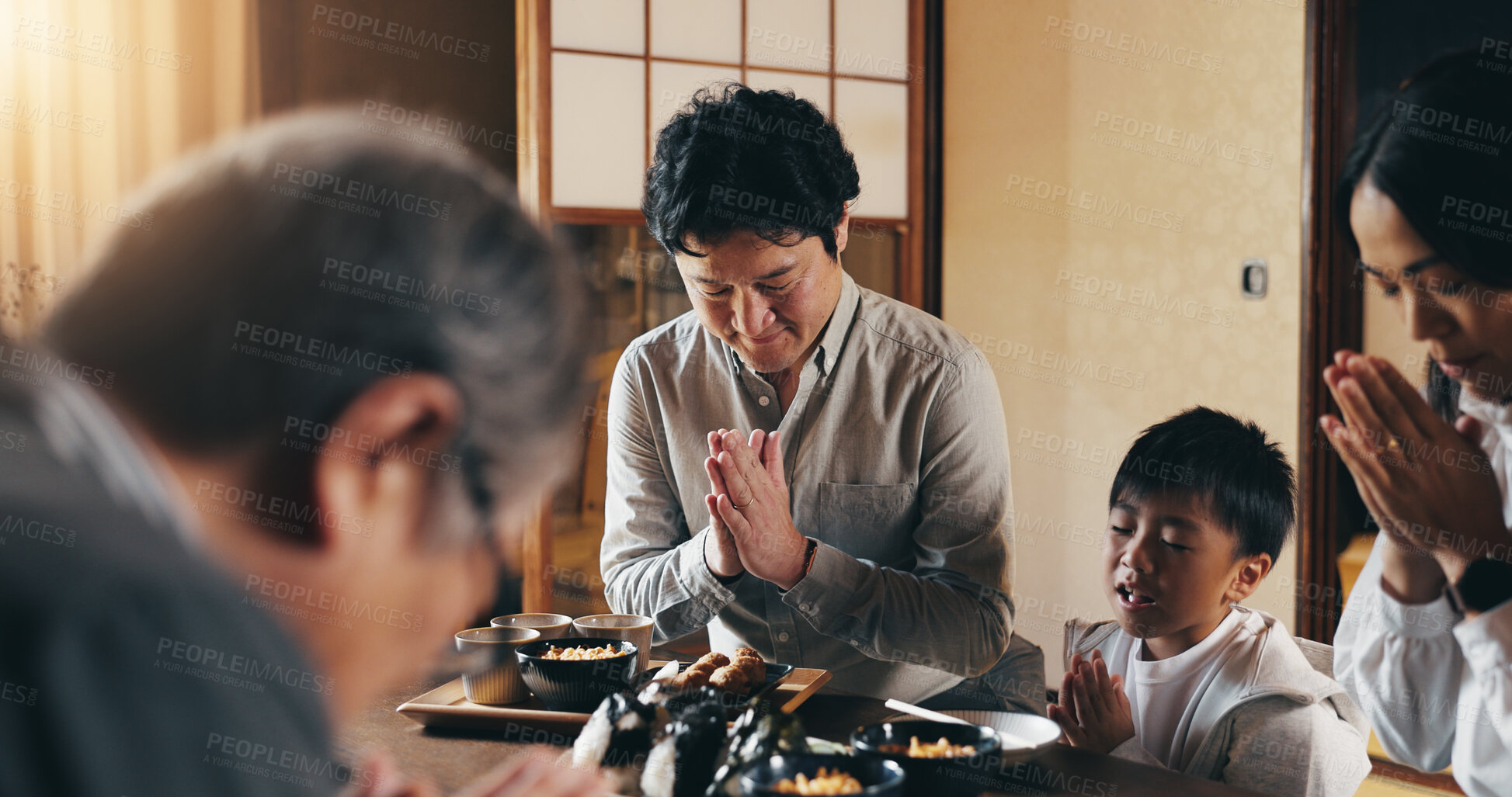 Buy stock photo Japanese, family and food in home with prayer, child and gratitude together with religion. Spiritual, hungry and dinner table with love, care and support with praying and meal for health and worship