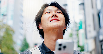 Buy stock photo Thinking, man and smile with phone in city for communication, travel location and map notification. Person, mobile and urban view for contact website, morning commute and schedule transport in Japan 