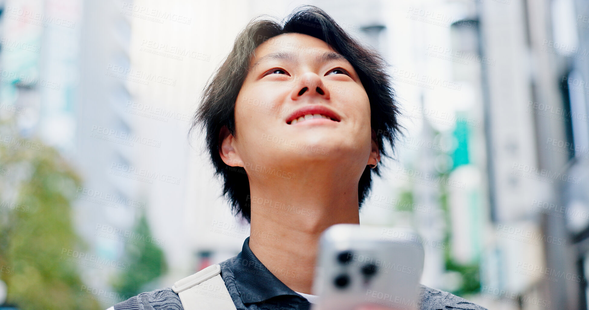 Buy stock photo Thinking, man and smile with phone in city for communication, travel location and map notification. Person, mobile and urban view for contact website, morning commute and schedule transport in Japan 