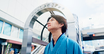 Buy stock photo Man, thinking and metro travel with traditional clothes, outfit and yukata for heritage. Japanese guy, holiday and pride for culture, journey and sightseeing with casual dress kimono fashion in city