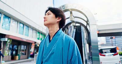 Buy stock photo Man, thinking and metro journey with traditional clothes, outfit and yukata for heritage. Japanese guy, holiday and pride for culture, travel and sightseeing with casual dress kimono fashion in city