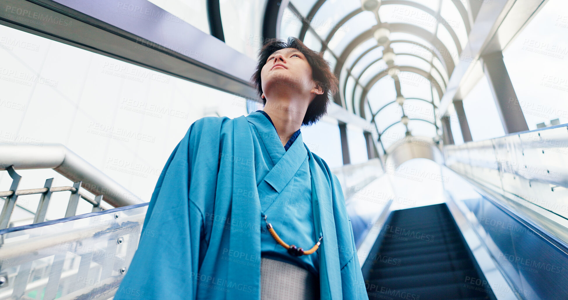 Buy stock photo Japanese man, thinking and escalator with traditional clothes, outfit and yukata for heritage. Guy, metro and holiday for culture, journey and sightseeing with casual dress kimono fashion in city