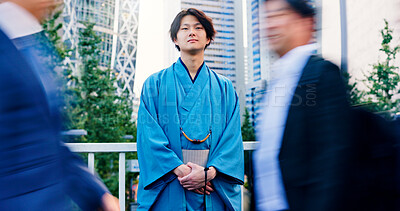 Buy stock photo Kimono, fashion and waiting with Japanese man in city for motion blur, culture and thinking. Respect, travel and reflection with person in japan for traditional clothes, Buddhism and festival