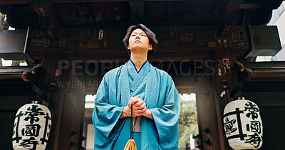 Buy stock photo Kimono, culture and low angle with Japanese man at temple for Shinto ceremony, fashion and prayer. Respect, travel and reflection with person in japan for traditional clothes, Buddhism and festival