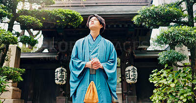 Buy stock photo Kimono, thinking and low angle with Japanese man at temple for Shinto ceremony, fashion and prayer. Respect, travel and reflection with person in japan for traditional clothes, Buddhism and festival