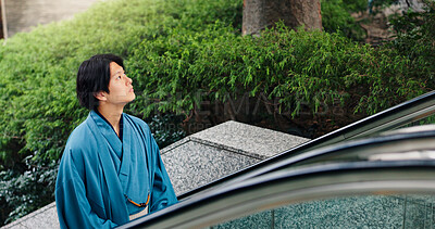 Buy stock photo Kimono, thinking and escalator with Japanese man in city for Shinto ceremony, fashion and culture. Respect, travel and reflection with person in japan for traditional clothes, Buddhism and festival