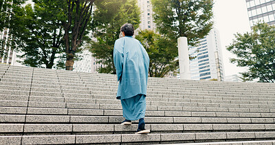 Buy stock photo Japanese man, back and steps with traditional clothes, outfit and yukata for heritage. Guy, holiday travel and pride for culture, journey and sightseeing with casual dress kimono fashion in city