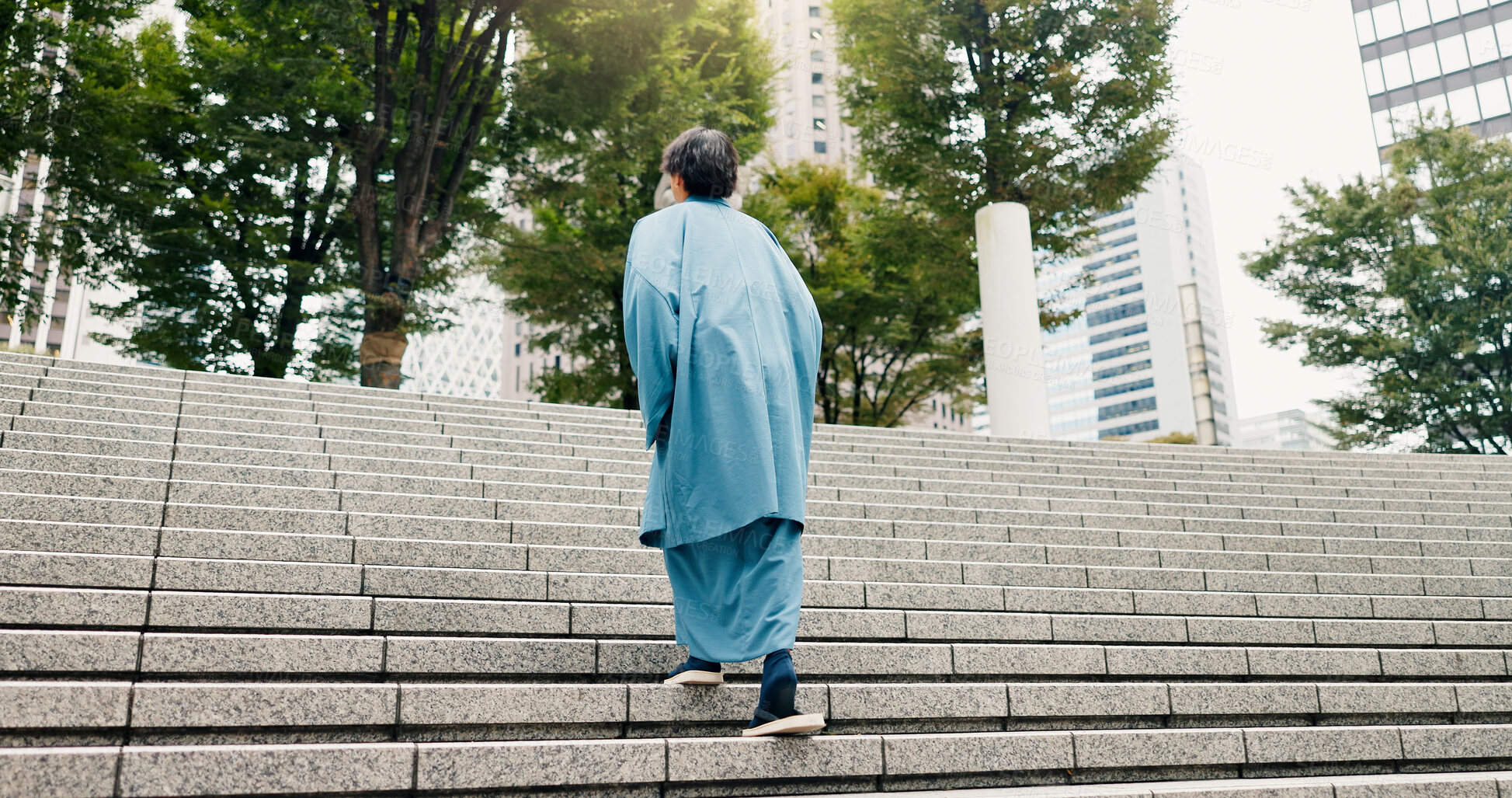 Buy stock photo Japanese man, back and steps with traditional clothes, outfit and yukata for heritage. Guy, holiday travel and pride for culture, journey and sightseeing with casual dress kimono fashion in city