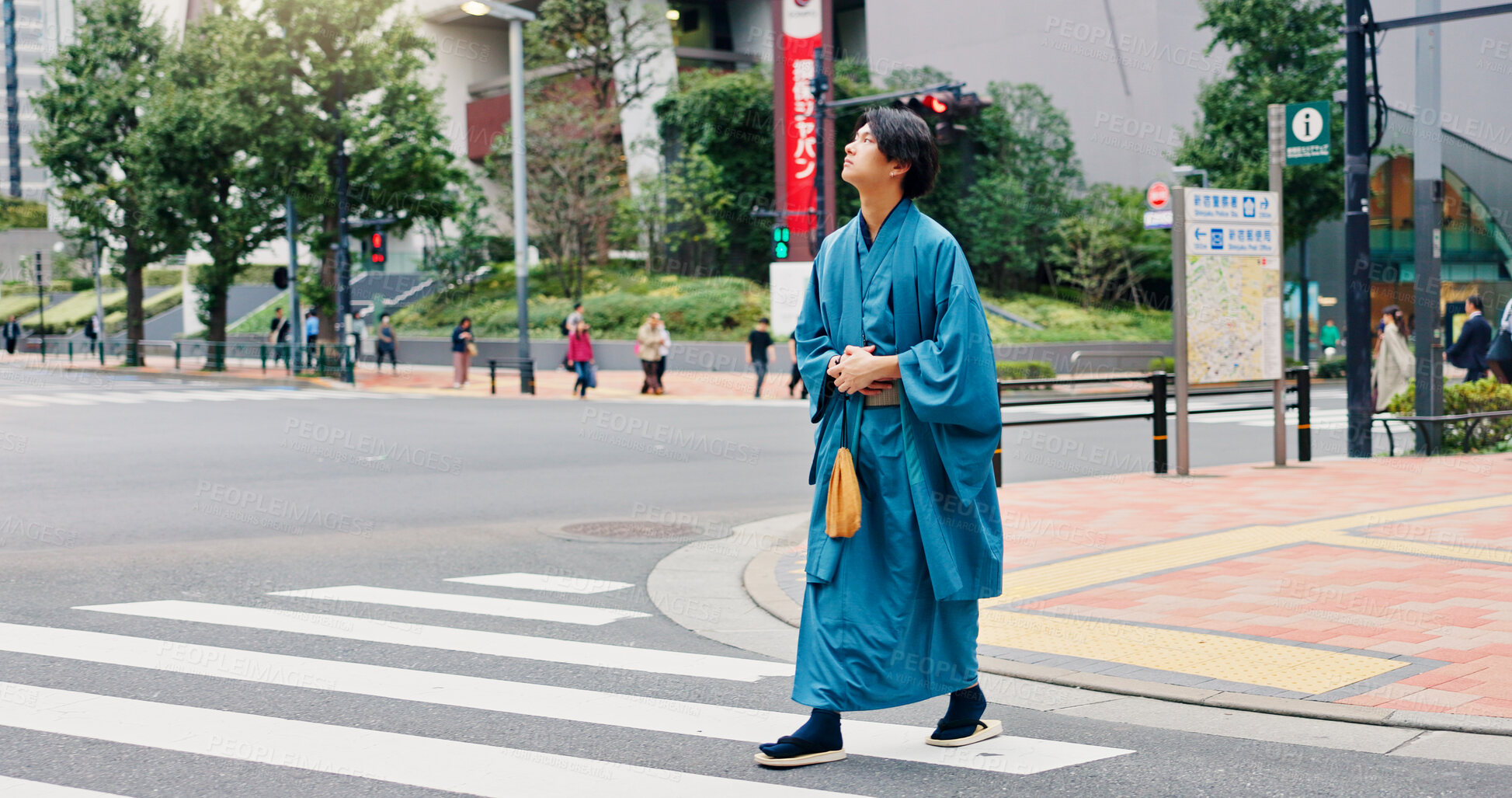 Buy stock photo Kimono, crosswalk and travel with Japanese man in city for ceremony, heritage and pride. Respect, urban and indigenous with person in japan street for traditional clothes, Buddhism and festival