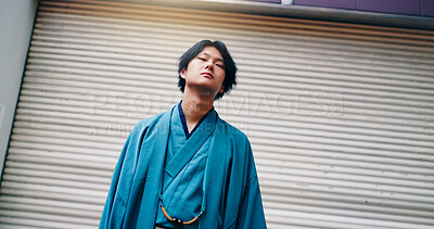 Buy stock photo Portrait, kimono and fashion for man, city and confident with clothes, indigenous and building. Outdoor, trendsetter and stylish with robe, low angle and serious for heritage and traditional in Japan