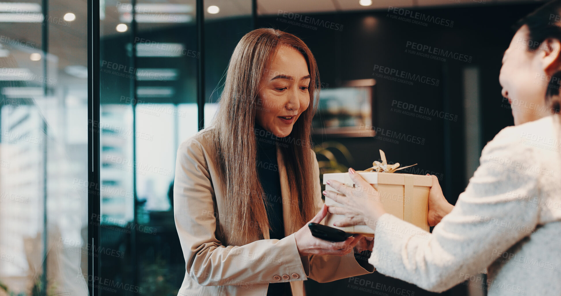 Buy stock photo Business people, gift and celebration with bow, gratitude and congratulations. Japan, employees or consultant in office, present and event for birthday, success or promotion with respect or thank you