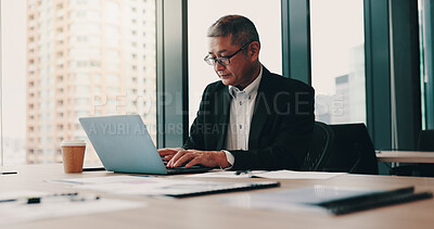 Buy stock photo Office building, Japanese businessman and laptop with typing, documents or project management as ceo. Mature, male person and paperwork on tech for online, connection and review in company or agency