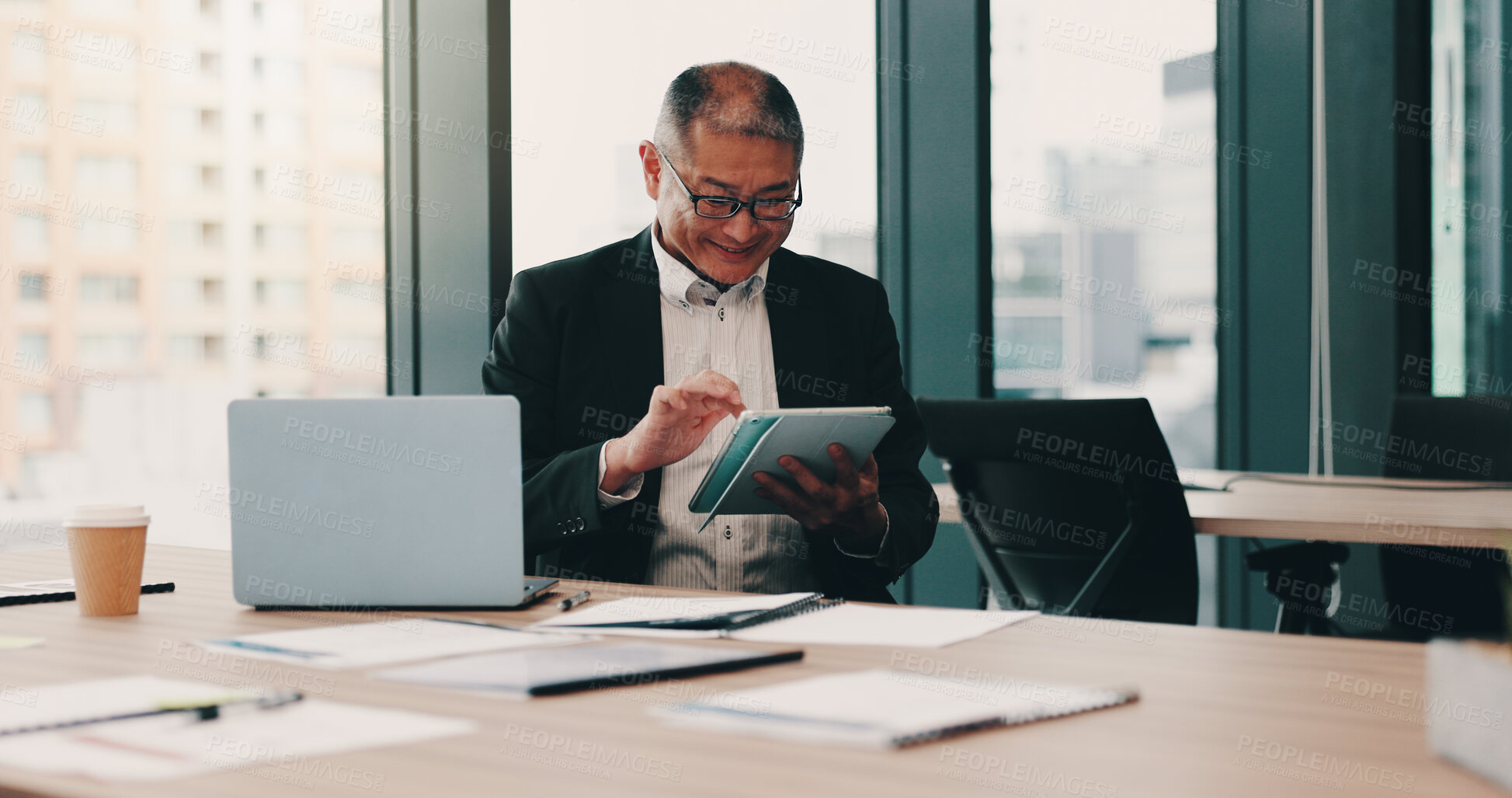 Buy stock photo Mature, Japanese businessman and excited on tech for communication, connection or internet. Male person, paperwork and happiness on tablet with laptop in office for news, online or website in company