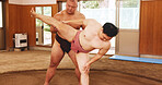 Men, ring and stretching in Japan for sumo, fitness and exercise with preparation, skill and technique. Japanese athlete, fighter and sports in dohyo for training, workout and wrestling with warm up