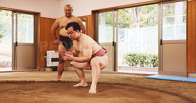 Buy stock photo Japan, man and sumo wrestling for sport, training and practice in dohyo ring. Tradition, wrestlers and Asian people exercise for culture, martial arts and coaching student for learning technique