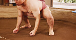 Body, dohyo and mawashi and with Sumo wrestler closeup for martial arts competition or tournament in Japan. Fight, power and strength with person in arena or ring for culture, heritage or pride