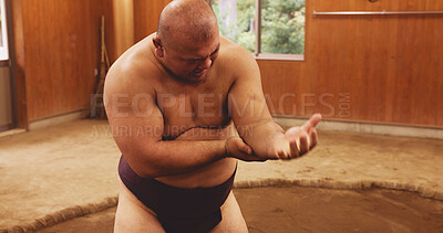 Buy stock photo Sumo wrestler, pain and man in studio, training and wellness with traditional sports. Japan, injury and person with muscle tension, broken and practice with bruise, dohyo ring and inflammation