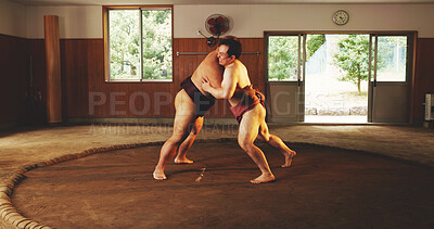 Buy stock photo Combat, fighting or Sumo wrestling with men in dohyo for Japanese competition, culture or tournament. Exercise, fitness or training with wrestler and rival in ring of arena for exhibition match