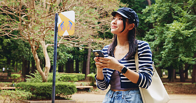 Buy stock photo Map, phone and thinking with woman in park for adventure, sightseeing or travel to explore Japan. App, idea and walking with happy tourist person in nature to search for directions to location