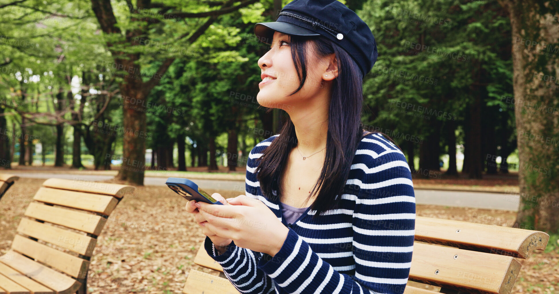 Buy stock photo Bench, phone and thinking with woman in park for adventure, sightseeing or travel to explore Japan. App, idea and social media with smile of happy tourist person outdoor in nature for vacation