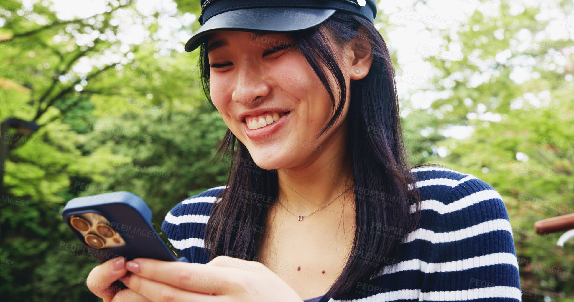 Buy stock photo Face, phone and smile with woman in park for adventure, sightseeing or travel to explore Japan. App, holiday and social media with happy tourist person typing message outdoor in nature for vacation