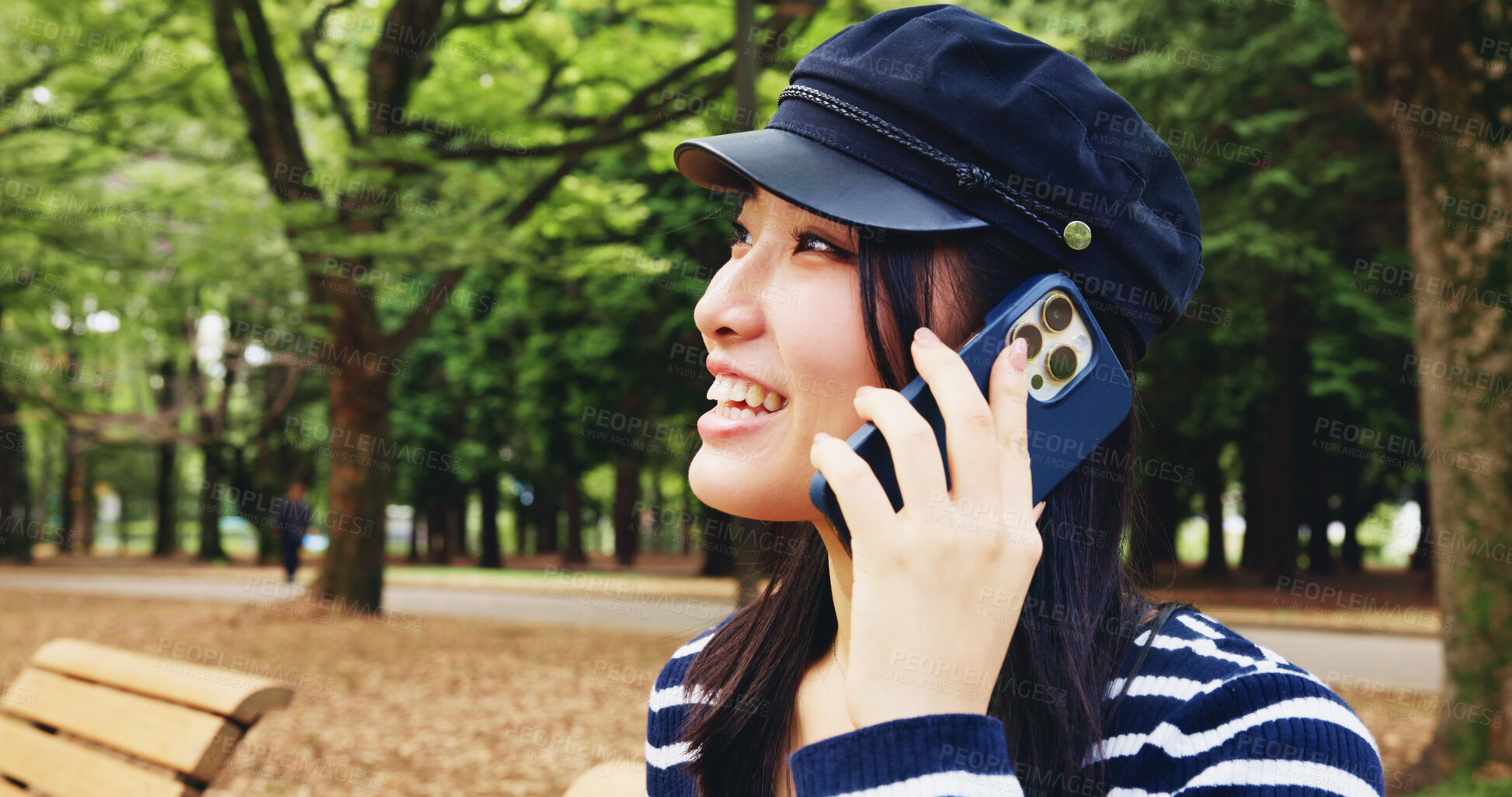 Buy stock photo Park, woman and happy with discussion on phone call for communication, contact and gossip in Japan. Outdoor, female person and smile at forest with listening for update, connection and conversation