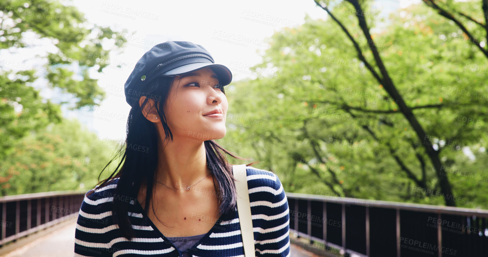 Buy stock photo Asian woman, tourist and bridge with nature for travel, sightseeing adventure or outdoor journey. Japan, female person or tourism with smile or natural view for holiday, dream or fresh air at park