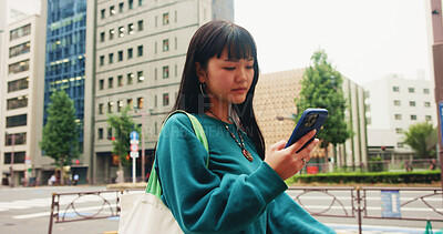 Buy stock photo Japanese, woman and travel with phone in city for communication, social media and chat notification. Girl, commute and mobile for navigation app of location, reading blog and website texting in Japan