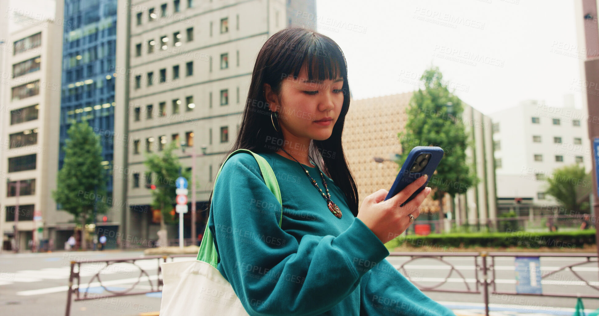 Buy stock photo Japanese, woman and travel with phone in city for communication, social media and chat notification. Girl, commute and mobile for navigation app of location, reading blog and website texting in Japan