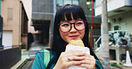 Travel, eating and woman with pastry in city on vacation, adventure or weekend trip for journey. Happy, food and hungry Japanese female person enjoying Taiyaki for lunch in urban town on holiday.