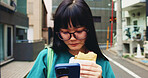 Browsing, student and woman with smartphone, snack and reading of timetable for exam, eating and campus. Outdoor, education and Asian person with food, scroll and check of schedule, mobile and Japan